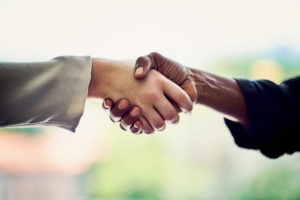 Cropped shot of unrecognizable businesswomen shaking hands in the office