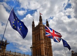 The European Union and UK flags flying outside tje House of Parliament in London as part of a Brexit protest