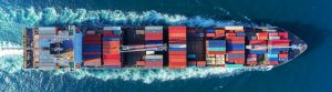 Aerial view Top speed with beautiful wave of container ship full load container with crane loading container for logistics import export or transportation concept background.